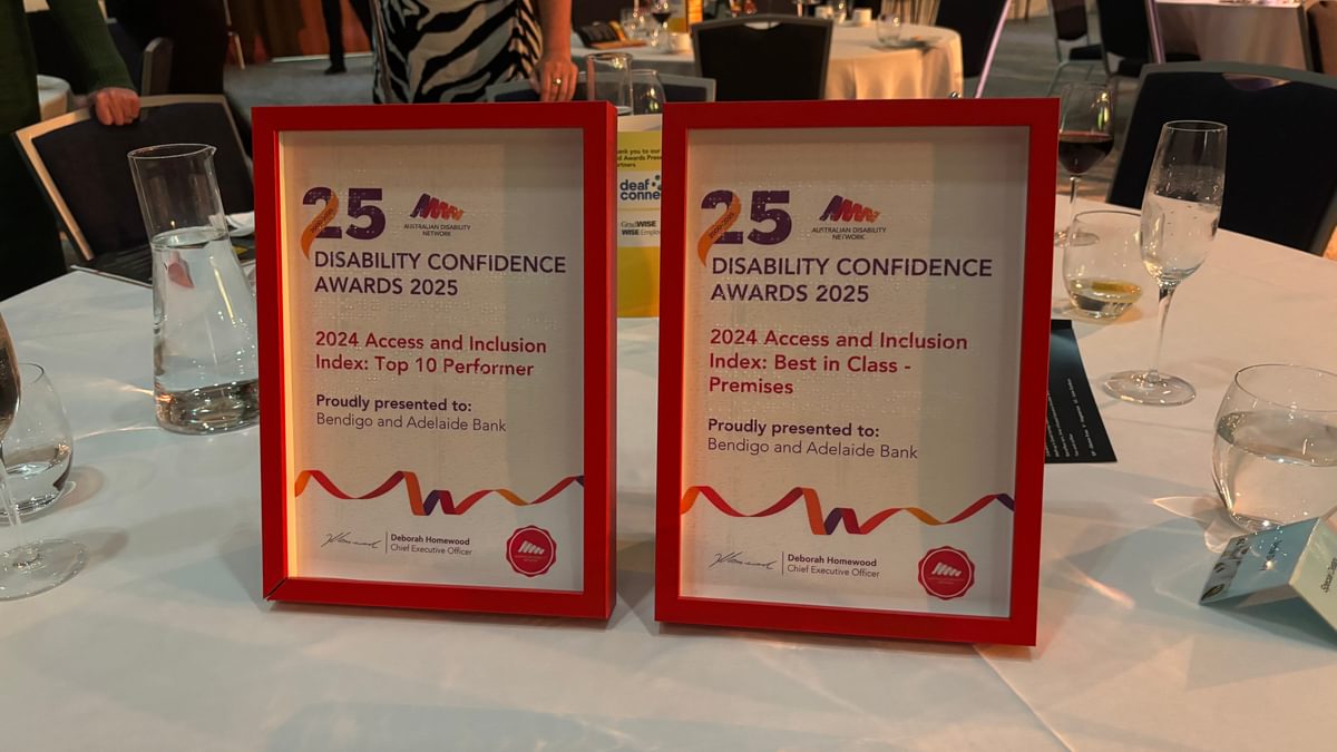 Two framed awards sitting on a white table. The award says: Disability Confident Recruiter Awards 2024 Access and Inclusion Index Top 10 performer proudly awarded to Bendigo and Adelaide Bank. The award on the right is an award for Best in Class - Premises for the 2024 Access and Inclusion Index.