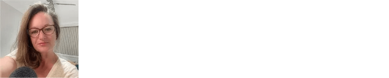 Samantha has long brown hair and is wearing glasses